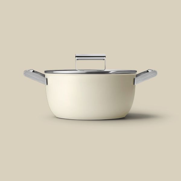 A non-stick cream casserole dish with 2 silver handles, and on top, sits a glass lid with silver handle.