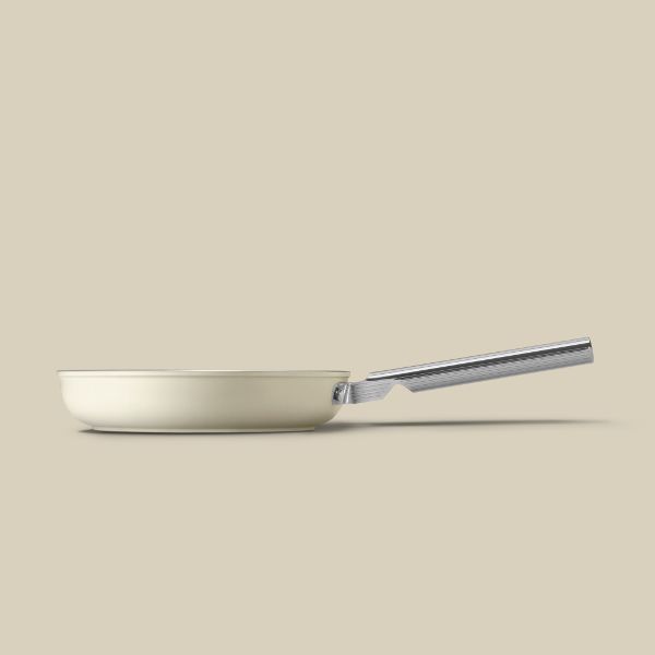 A non-stick frying pan with a stainless steel outer. Features a polished stainless steel handle, and a glass lid with a stainless steel handle