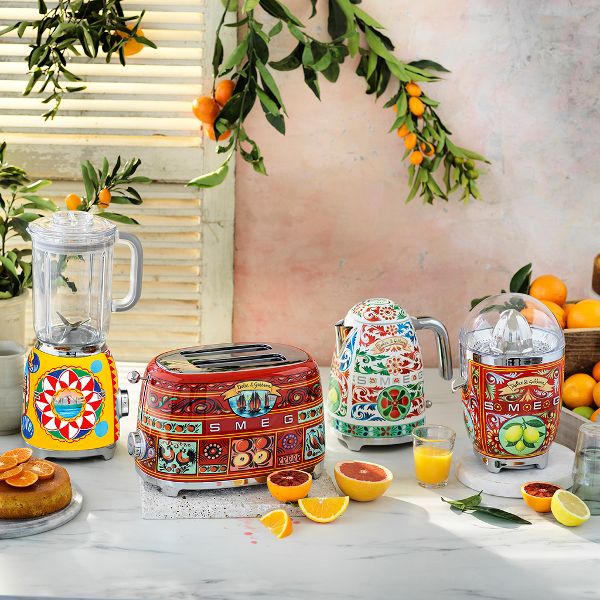 Smeg's Siciliy is my Love toaster, kettle, citrus juicer and blender on a while marble kitchen worktop, in a Mediterranean kitchen highlighting the vibrancy and variety of their intricate hand painted designs