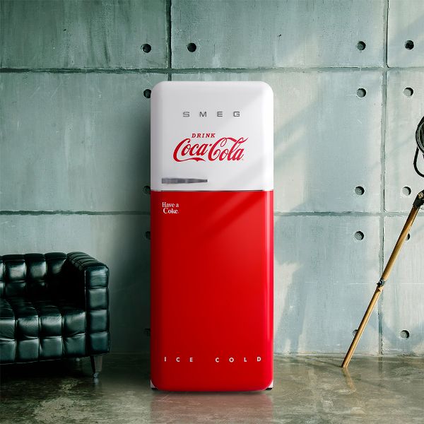 Smeg's iconic Cola Cola designer fridge line. The bottom 60% (arox) is in Coca Cola brand red, and the top 40% of the door is in white, and features the iconic Coca Cola brand logo