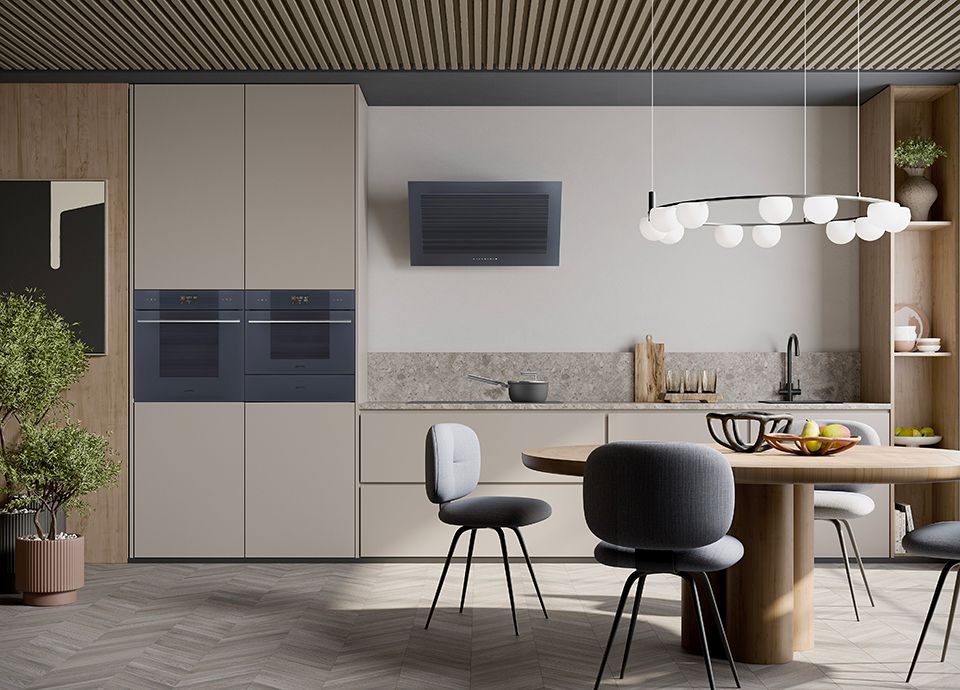 A kitchen with light coloured units, and integrated cookers (side by side) in Neptune Grey, and a Neptune Grey extractor hood