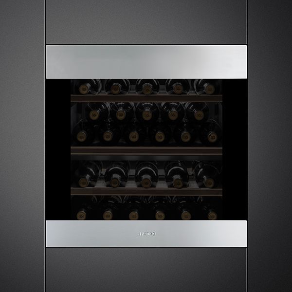 A classic built-in wine cooler with silver top and bottom door panels and darkened glass, displaying  27 bottles