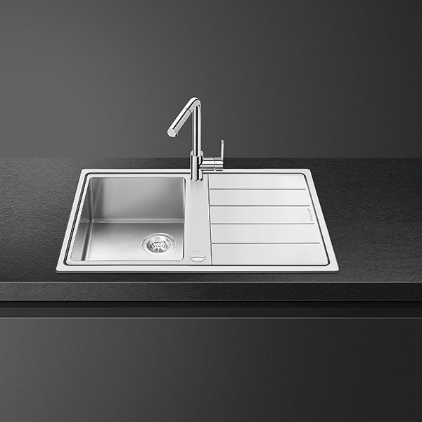 An ultra-low profile stainless steel sink with built-in drainage board