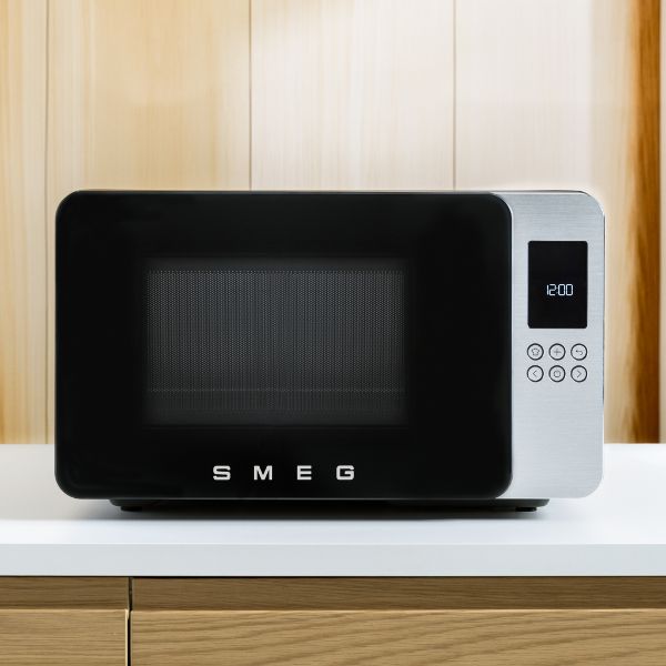 A counter top microwave in silver, with touch button controls