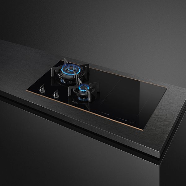 A black mixed fuel hob featuring 2 gas burners on the left (1 large burner and 1 small), and low profile induction zone on the right