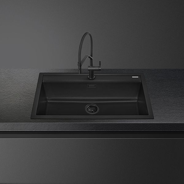 A narrow depth, black composite sink. Also shown is a designer up-and-over monobloc black tap with a single lever.