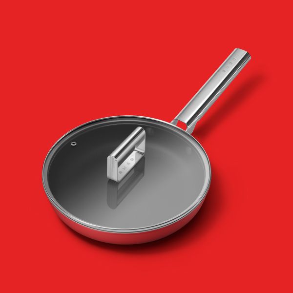 A non-stick frying pan with a stainless steel outer. Features a polished stainless steel handle, and a glass lid with a stainless steel handle