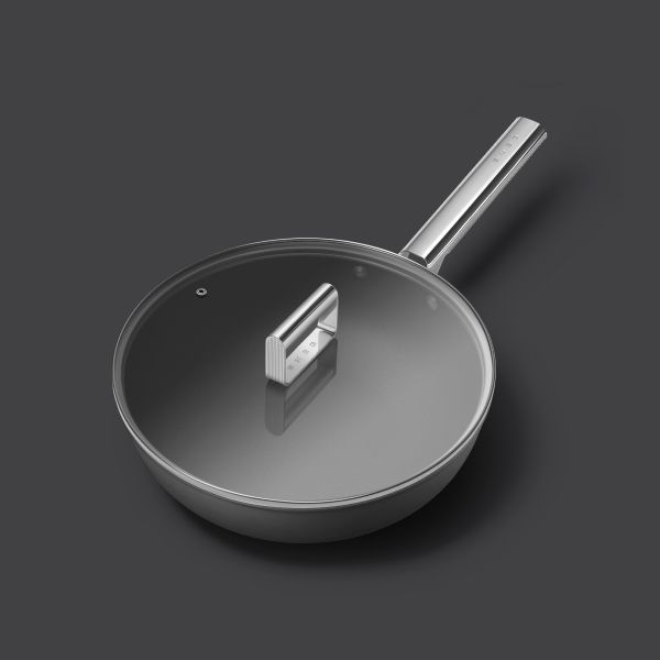 A matt black, non-stick wok with stainless steel handle. On top sits a glass lid with stainless steel handle