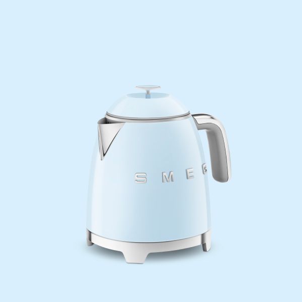 A mini Kettle in pastel blue with chrome handle, spout and base in Smeg's iconic retro design