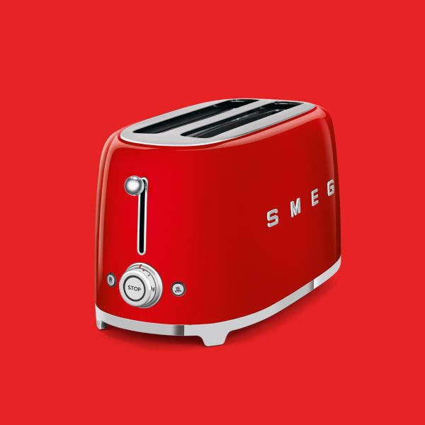 A bright red 4 slice, 2 slot toaster in Smeg's iconic retro design with rounded edges and chrome controls